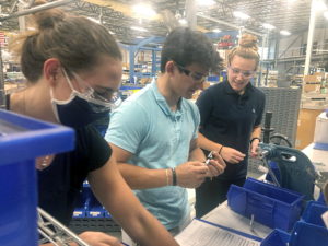 Picture of Mack interns working on the manufacturing line.