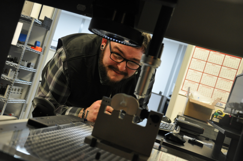Metrology Applications Engineer Dakota Burdick measures parts