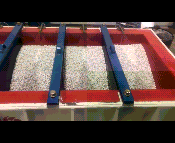 Metals parts running through a deburring machine