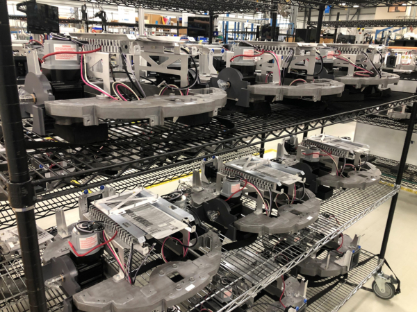 Photo of contact manufacturing services manufacturing line. Assembled parts sitting on a rack after completion.