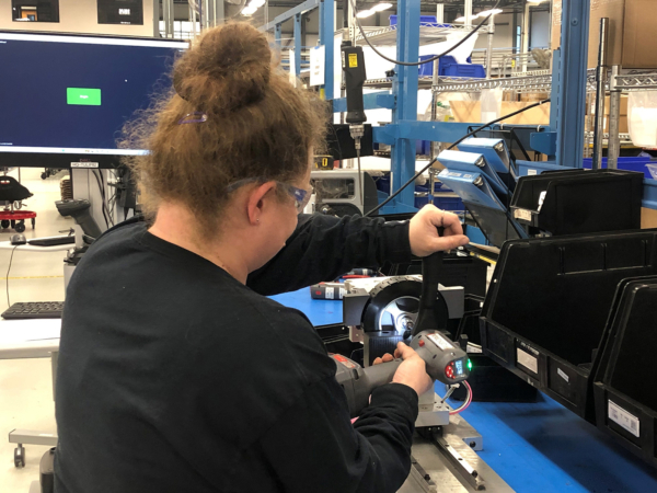 Photo of staff member assembling a part.