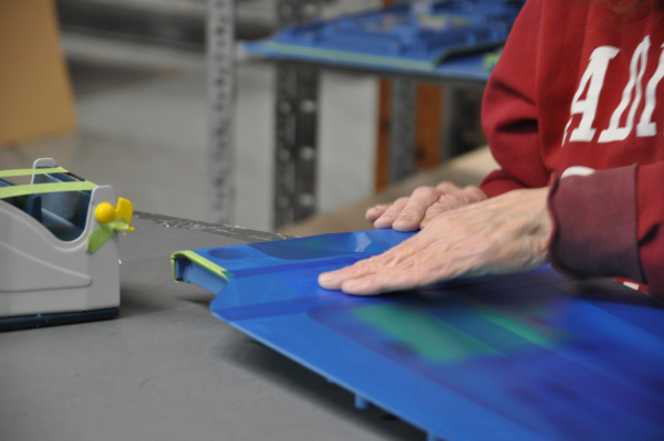 Prepping a part for painting & finishing services.