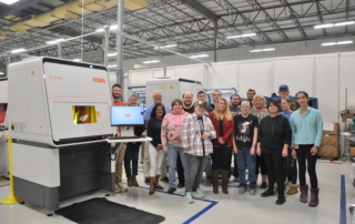 Mack employees with their new laser marking stations.
